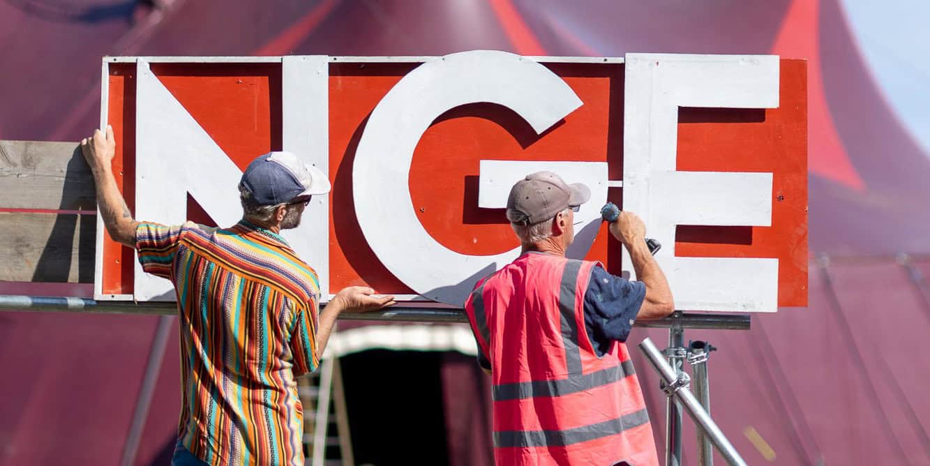 Two people constructing large signage for Ventnor's Fringe Festival