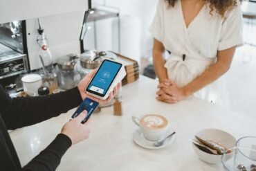 person paying for coffee in cafe