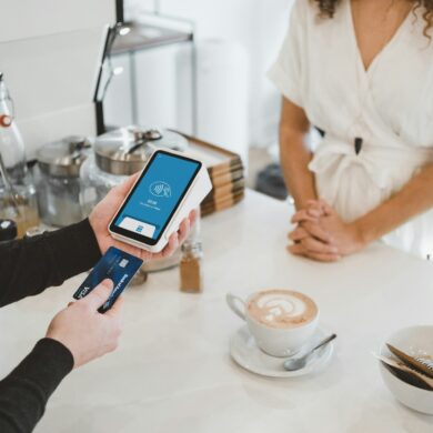 person paying for coffee in cafe