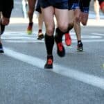 shot of people's legs and feet running in a marathon