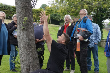 Ben showing new wardens how to checking tree health