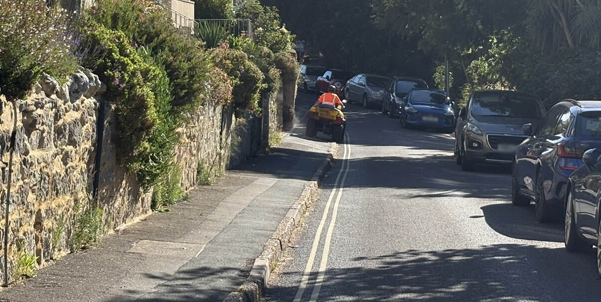 Island Roads contractor on a quad bike spraying glyphosate - Madeira Road, Ventnor
