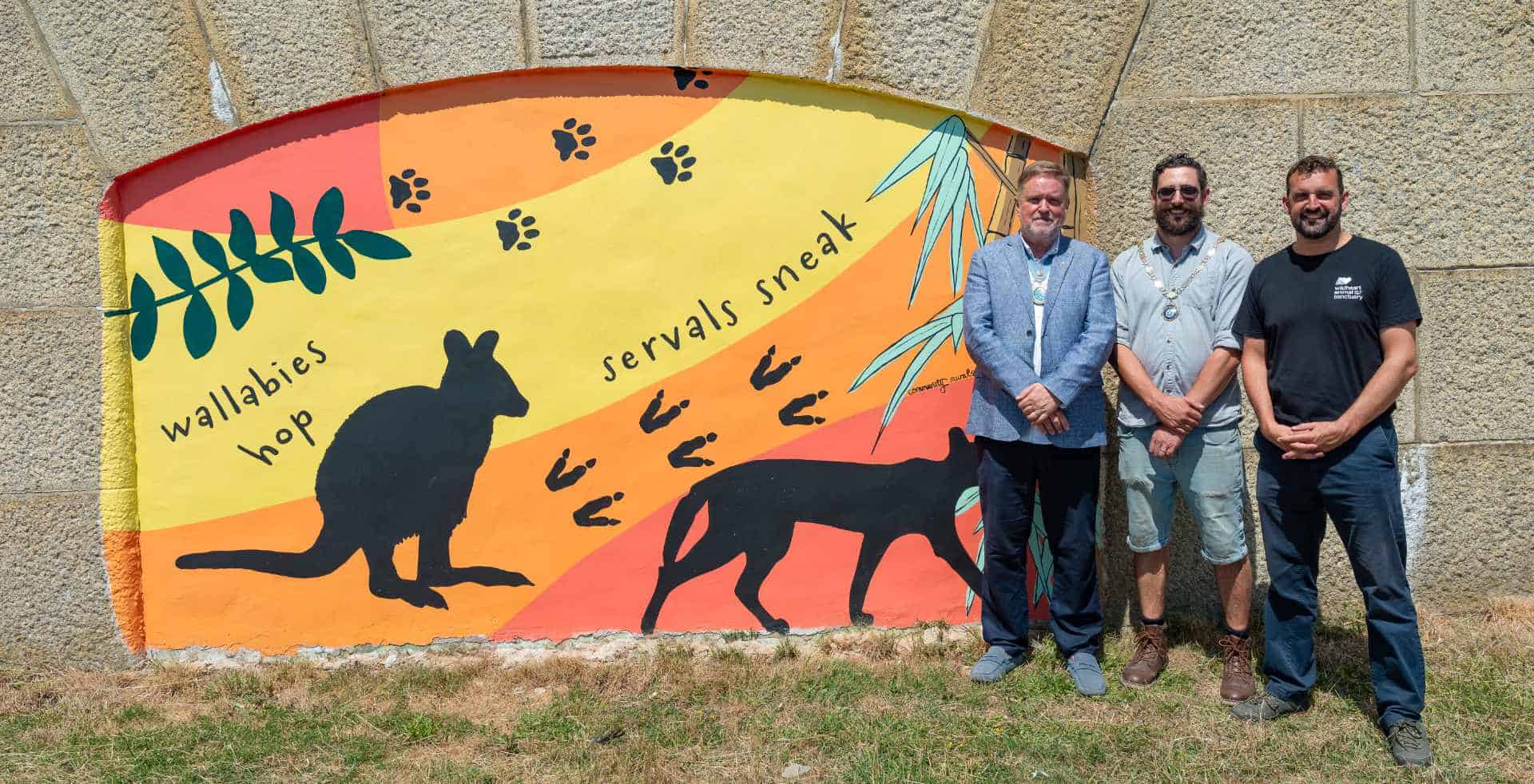 Pupils and dignitories attending the official opening of the murals
