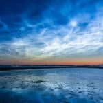 Noctilucent clouds over a beach