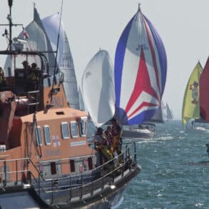 Boats with their colourful spinnakers up for Round the Island Race 2026 = RNLI looking on