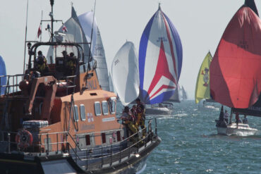 Boats with their colourful spinnakers up for Round the Island Race 2026 = RNLI looking on