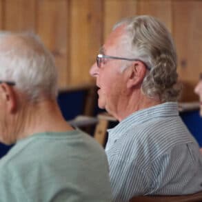 Photo of the backs of three people with Paul Wyatt in the centre