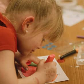 A child taking part in craft activities at Merry and Bright event