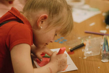 A child taking part in craft activities at Merry and Bright event