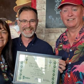 Steph Moorton and Reg White from the Ale House Cowes, winners of Pub of the Year 2025 receive their awards for Pub of the Year from Richard Quigley MP