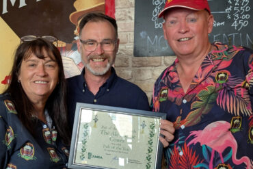 Steph Moorton and Reg White from the Ale House Cowes, winners of Pub of the Year 2025 receive their awards for Pub of the Year from Richard Quigley MP