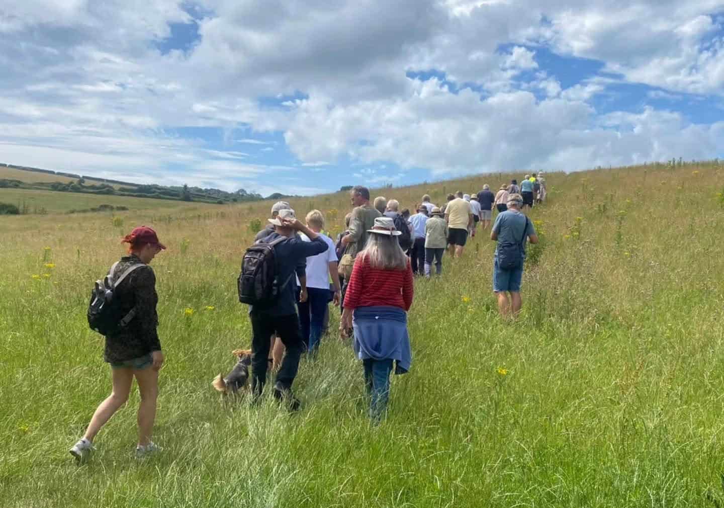 Group of people walking through fields