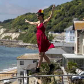 Tightrope walker on a tightrope with Ventnor bay in the background