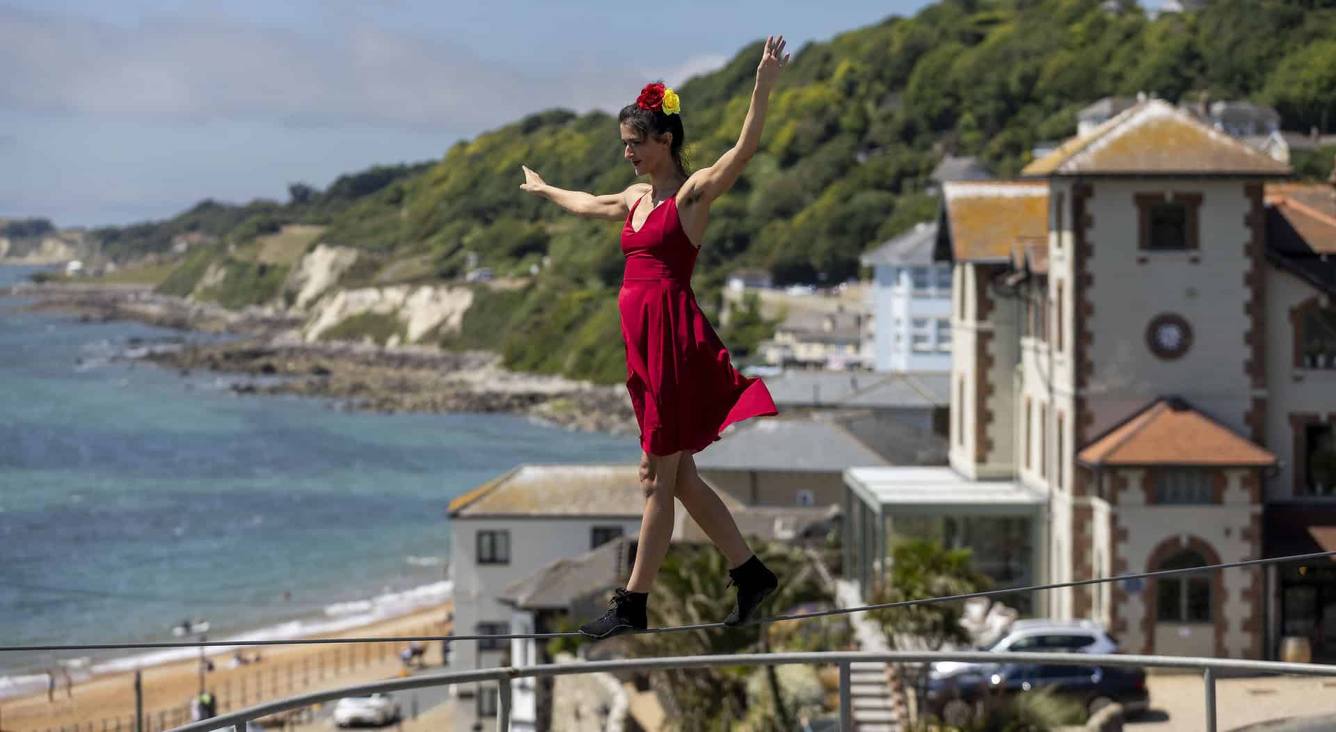 Tightrope walker on a tightrope with Ventnor bay in the background