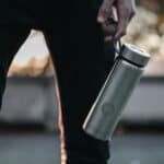 man holding reusable water bottle