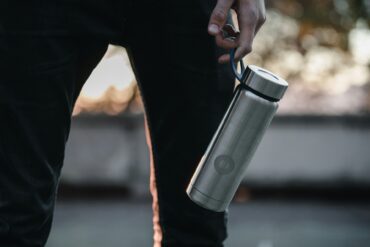 man holding reusable water bottle