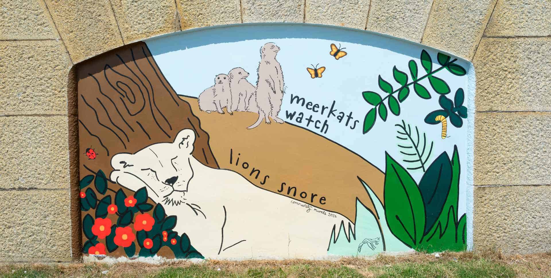 Pupils and dignitories attending the official opening of the murals