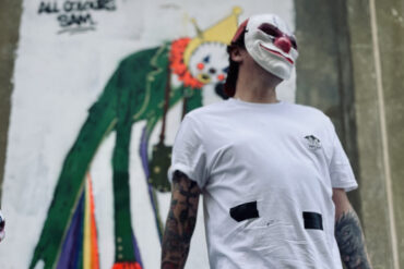 Portrait of masked graffiti artists who worked on Sandown Clown street art
