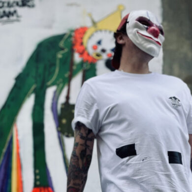Portrait of masked graffiti artists who worked on Sandown Clown street art