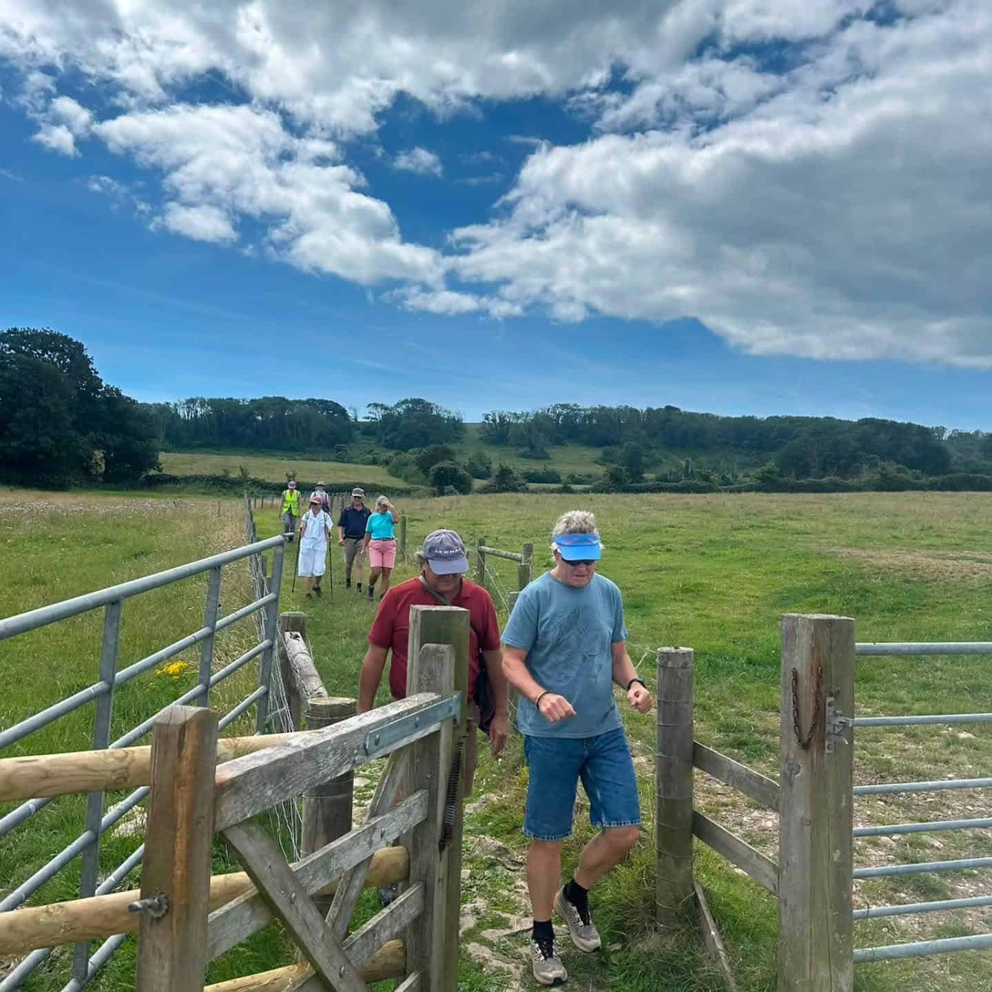 Group of people walking through fields
