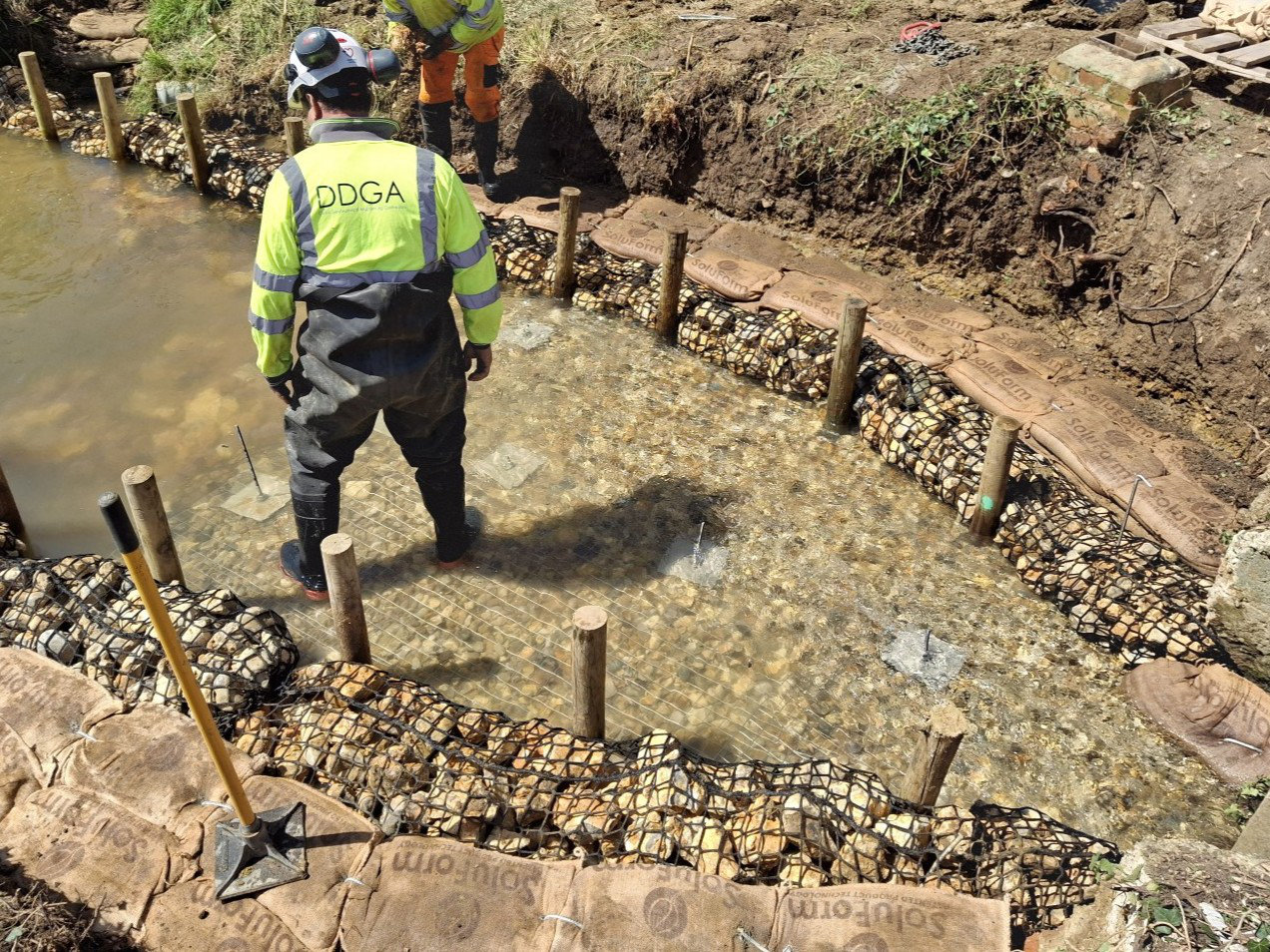 During the work at Muggleton Bridge - worker stood in the brook
