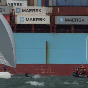 Huge container ship in the background with Gosport Lifeboat, a kitesurfer and a yacht in the foreground