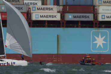 Huge container ship in the background with Gosport Lifeboat, a kitesurfer and a yacht in the foreground