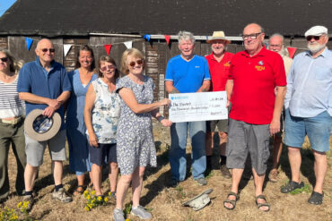 Shed members with Trustees accepting a Donation to the Haven