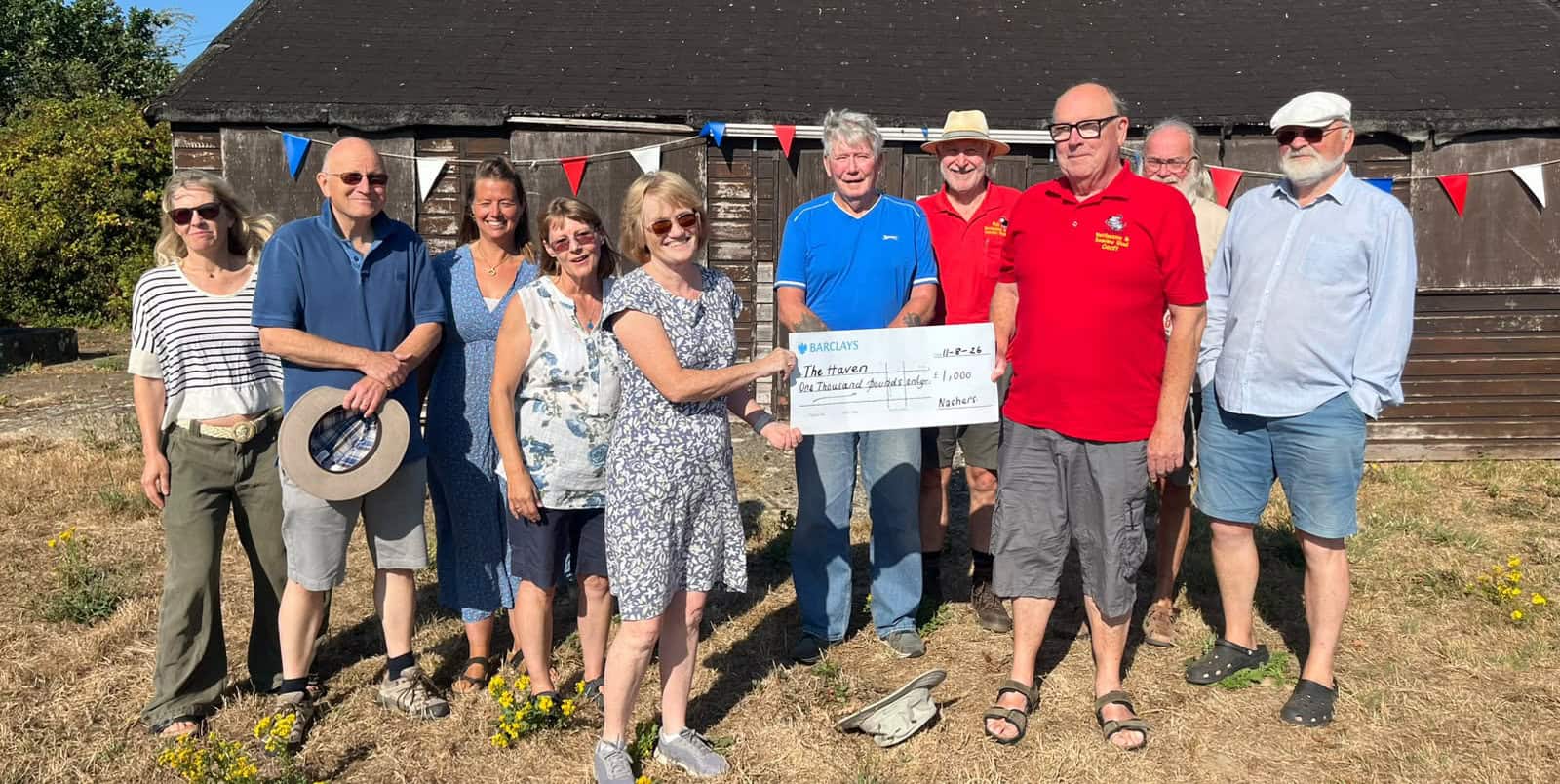 Shed members with Trustees accepting a Donation to the Haven