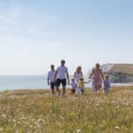 Family walking on hillside near freshwater bay -