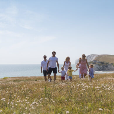 Family walking on hillside near freshwater bay -