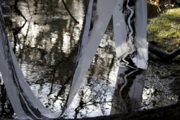 Painted fabric draping into a pond