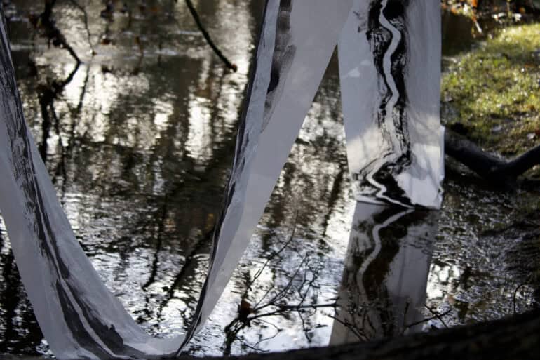 Painted fabric draping into a pond