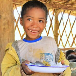 A child in Madagascar, holding a daily meal