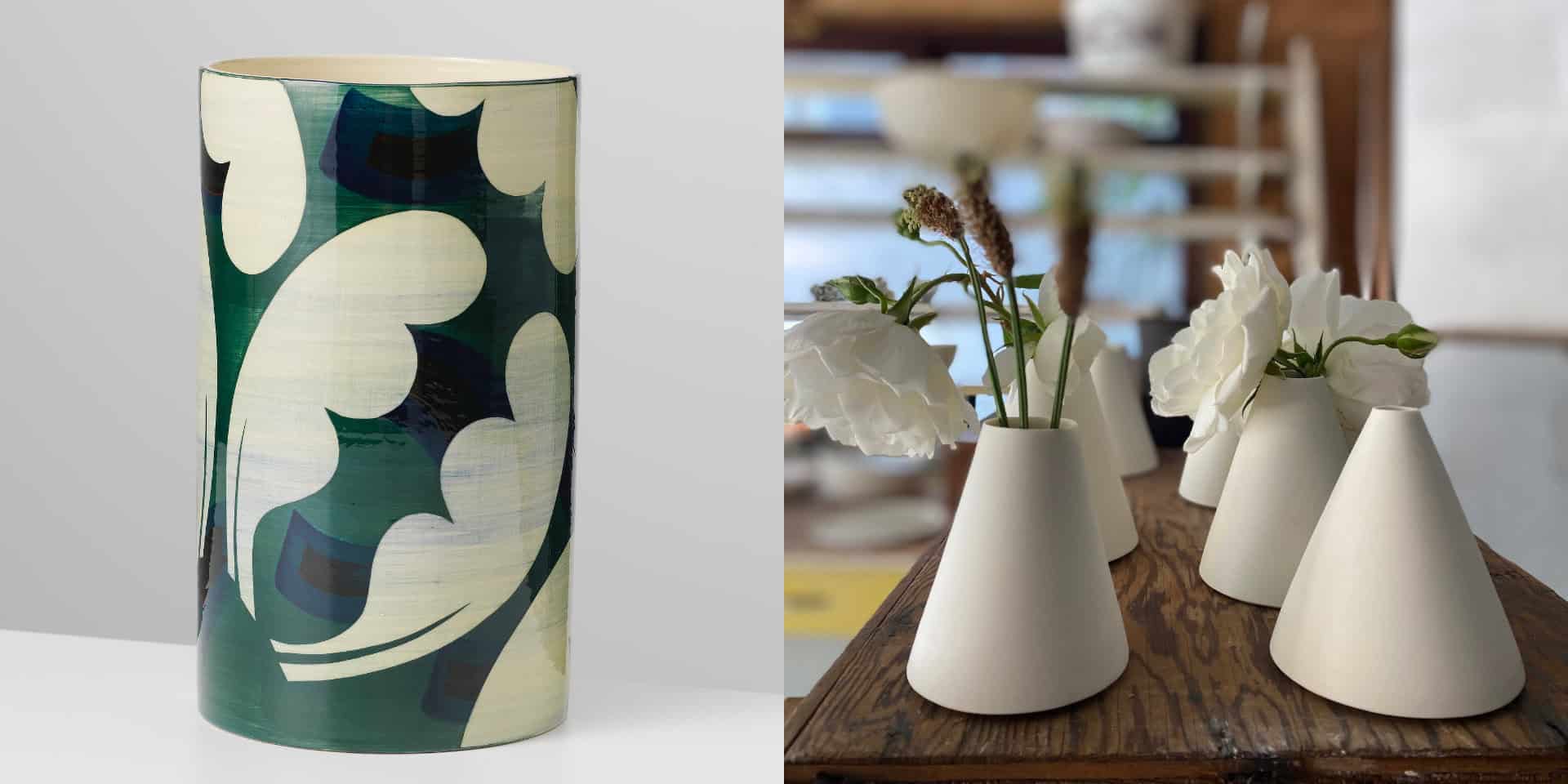 A case with abstract patterns painted on in cream and blue alongside a series of small cream ceramic vases on a wooden shelf