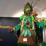 Large green man folk puppet in art gallery