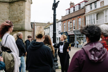 Charlotte at St Thomas's square speaking to walking tour audience