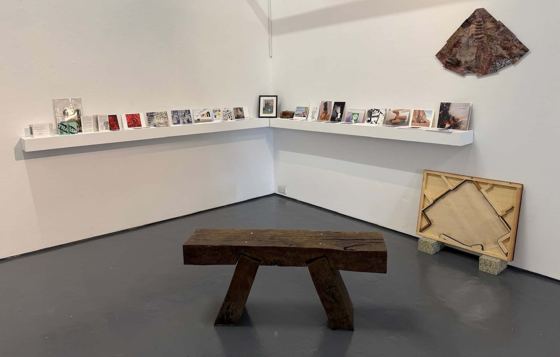 Shelves with items on connected to exhibitions and events at Quay Arts over the decades