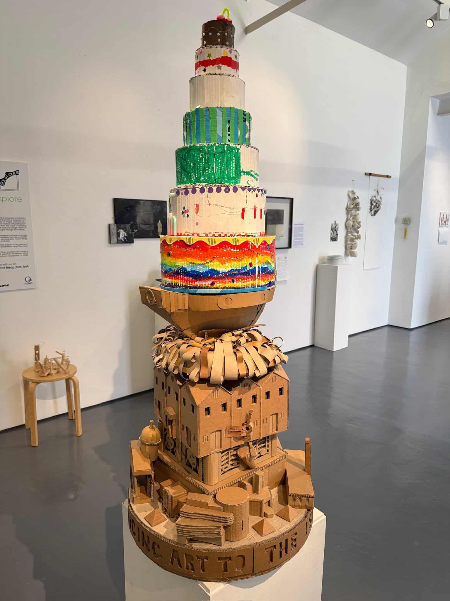 Co-created cardboard birthday cake on top of cardboard sculpture of Quay Arts Centre