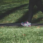 Woman jogging through a park