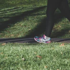 Woman jogging through a park