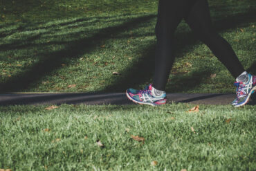 Woman jogging through a park