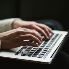 Woman typing on laptop keyboard
