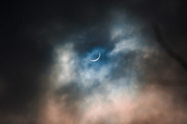 partial solar eclipse on a cloudy day