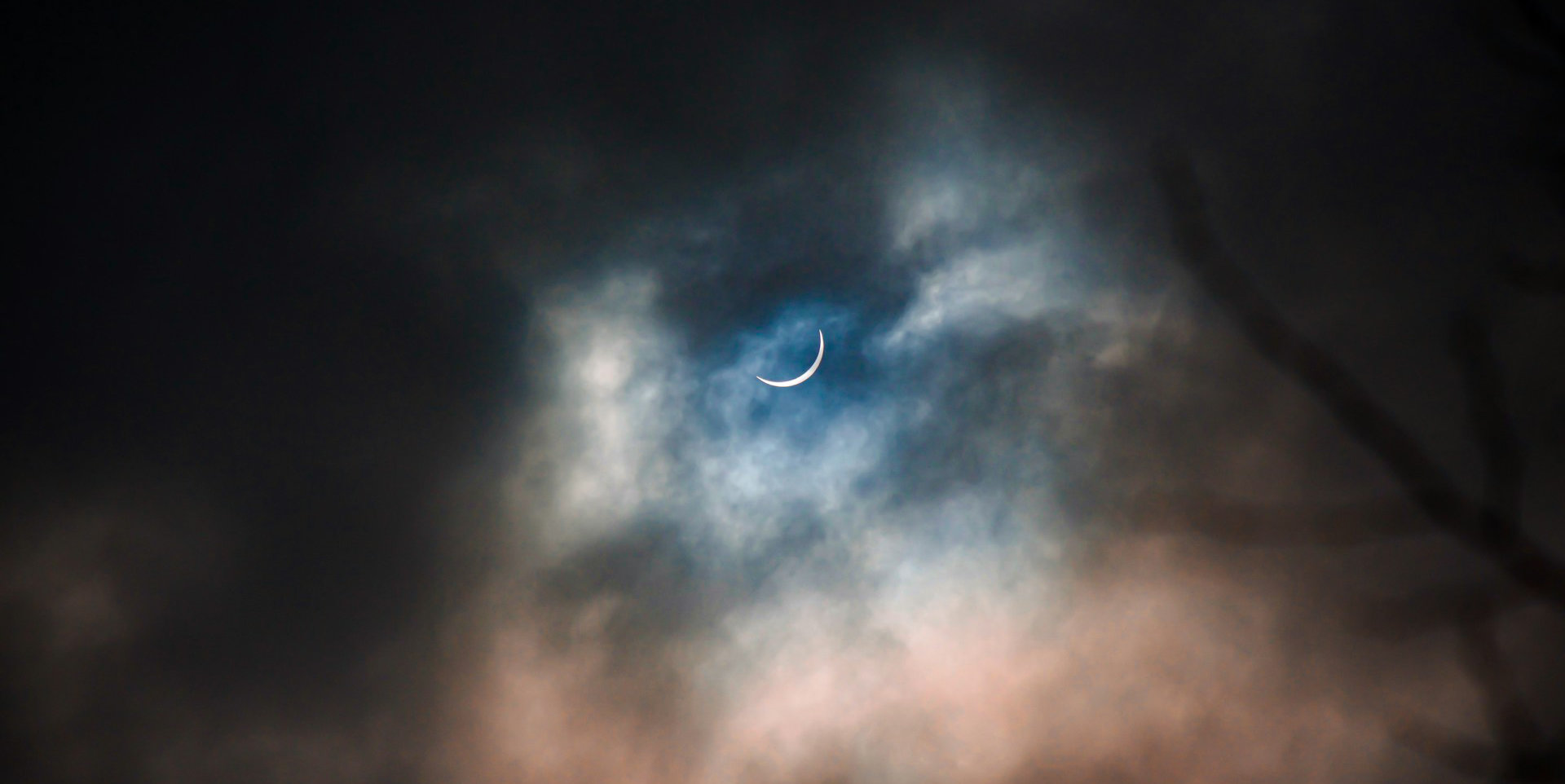 partial solar eclipse on a cloudy day