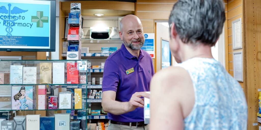 pharmacist dispensing medication to customer 1