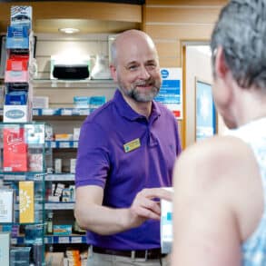pharmacist dispensing medication to customer 1