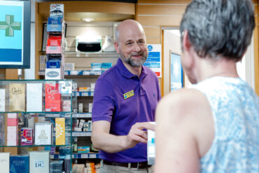 pharmacist dispensing medication to customer 1