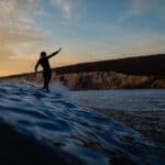 Colour photo of someone surfing in the sea off the Isle of Wight