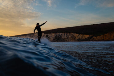 Colour photo of someone surfing in the sea off the Isle of Wight